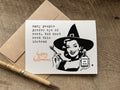 A Halloween greeting card with a black-and-white witch illustration and the text 'many people prefer eye of newt, but most need this instead' and 'happy halloween' in orange.  Features a retro woman in a witch hat holding a bottle that sayscommon sense potion.