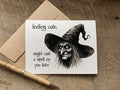 halloween greeting card with a black illustration of a creepy old witch wearing a pointed hat. The card reads, 'feeling cute, might cast a spell on you later.