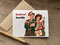 funny christmas card with retro couple sporting crabby scrooge looks and says  festive? hardly