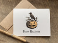 happy halloween card with vintage style graphic of a crow and pumpkin