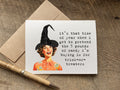 A halloween greeting card with a vintage-style illustration of a woman in a witch hat and a humorous quote, it’s that time of year when i get to pretend the 5 pounds of candy i’m buying is for 
trick-or-treaters