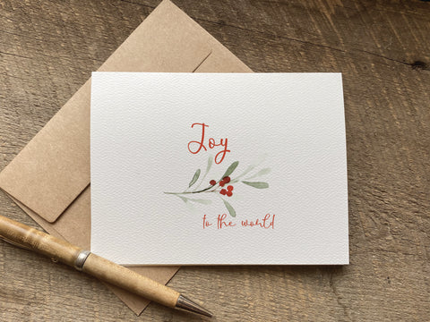 minimalist watercolor christmas card that says joy to the world