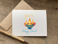 Greeting card with Diwali design featuring lit candles that says light and love happy diwali