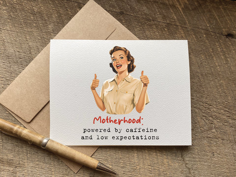 funny mothers day Card with illustration of a retro woman giving thumbs up, text 'Motherhood: powered by caffeine and low expectations'