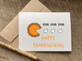 Thanksgiving card with a pie illustration eating whipped cream and 'nom nom nom happy thanksgiving text