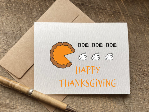 Thanksgiving card with a pie illustration eating whipped cream and 'nom nom nom happy thanksgiving text