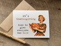 A square white greeting card with a vintage-style illustration of a woman holding a turkey The card reads, 'it's thanksgiving time to give everyone the bird,' 